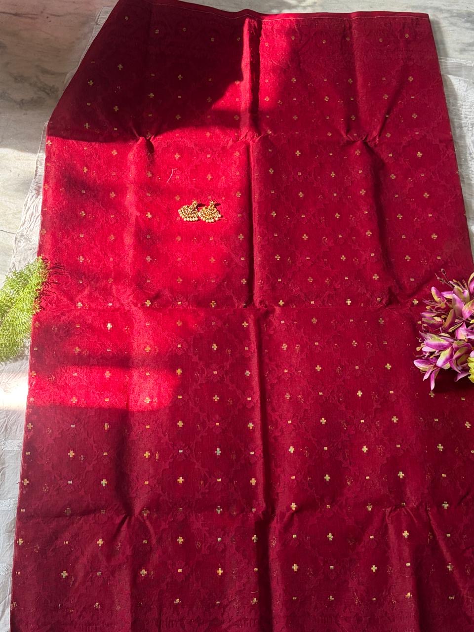 Dhakai Jamdani saree in a vibrant crimson or cherry red